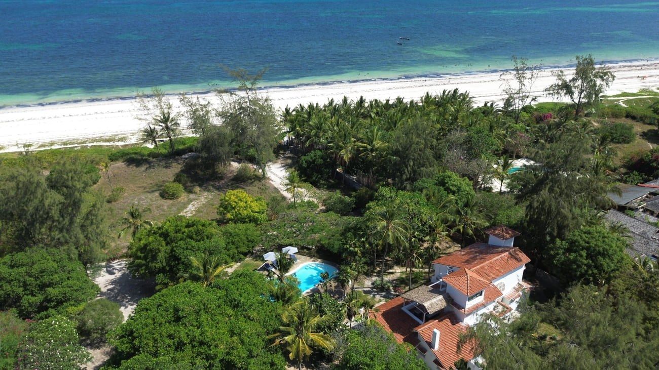 Aerial view of Sandbox villa, its private pool and tropical gardens above Bofa Beach and the Indian Ocean, Kilifi
